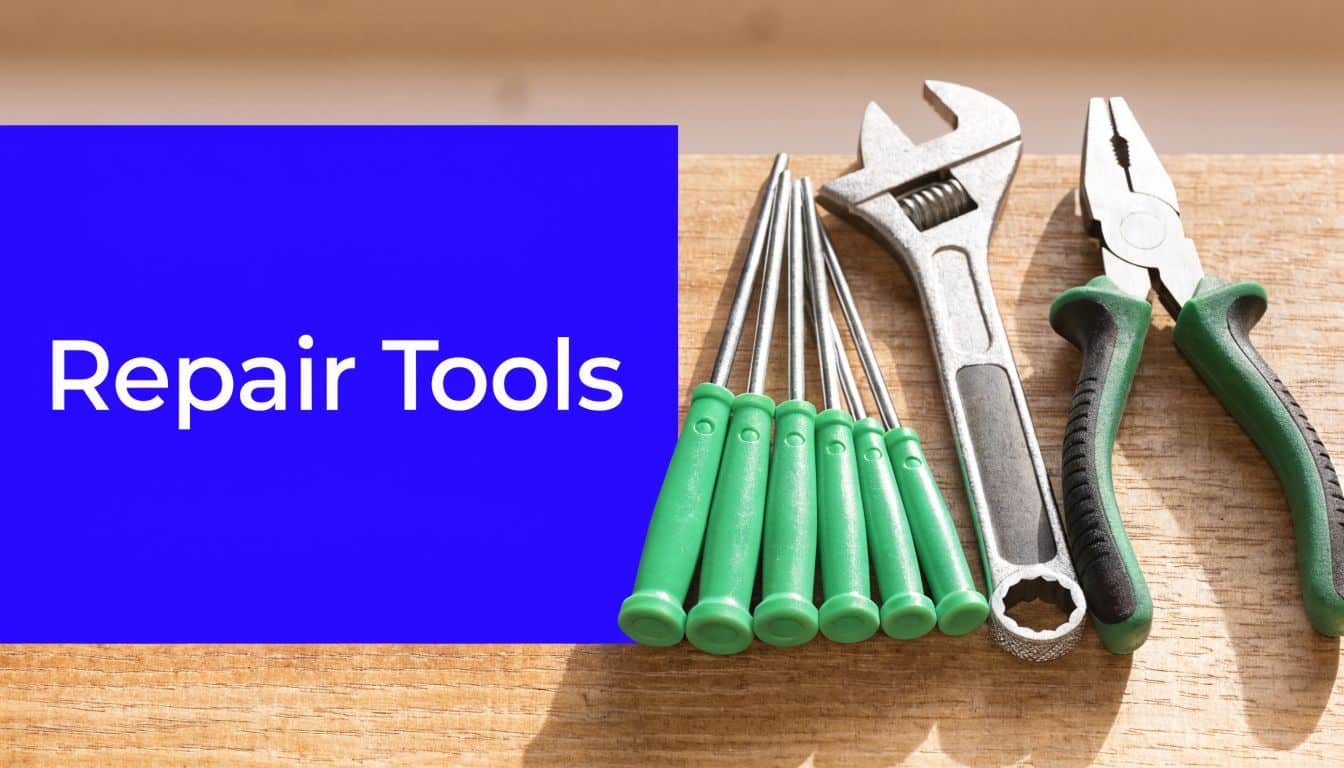A collection of assorted metal hand tools with green handles arranged on a light wooden background.