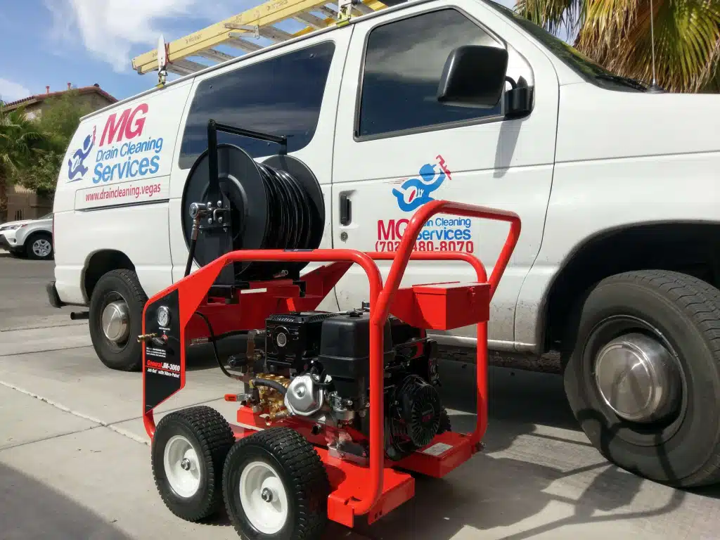 MG Drain Services hydro jetting hose feeding into a sewer cleanout at a Las Vegas home